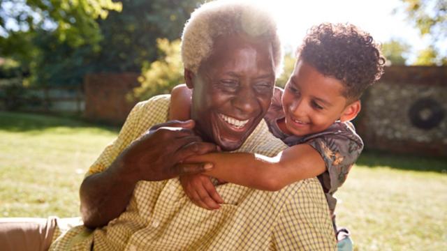 Grandfather and grandson hug outside